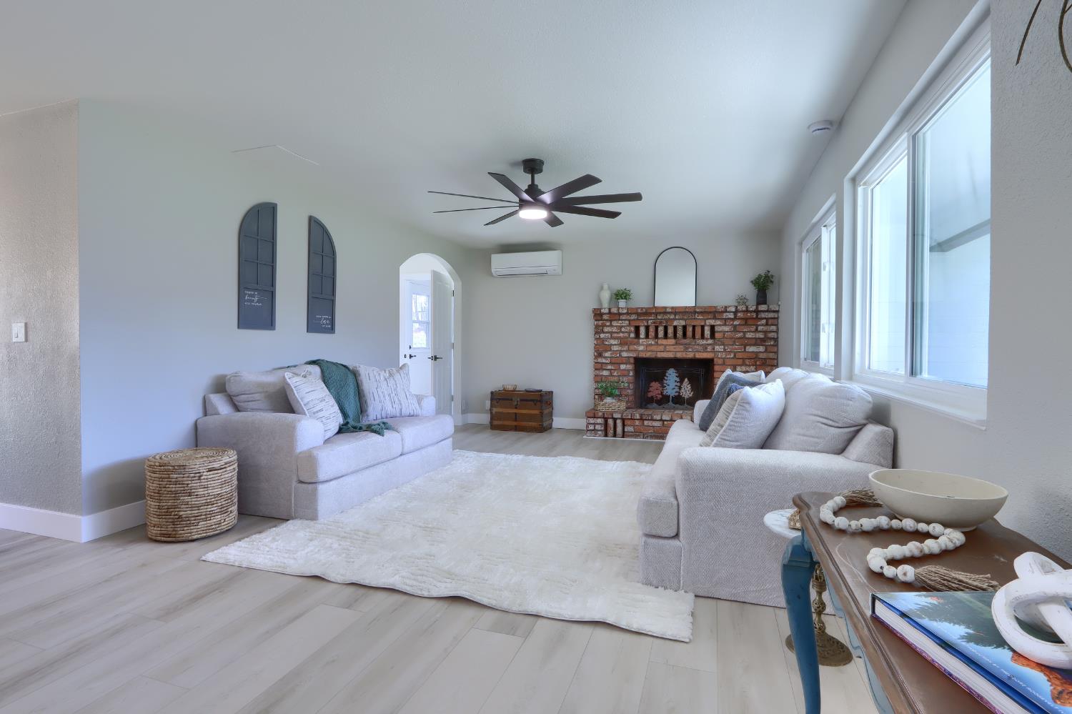 5518 East Whitlock Road Mariposa, CA 95338 - Photo 9 of 57 a living room with furniture a fireplace and a large window