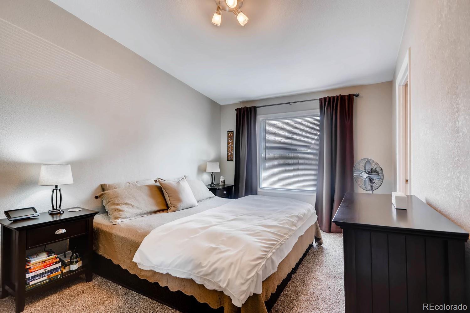 520 South Raleigh Street Denver, CO 80219 - Photo 15 of 27 a bedroom with a bed and lamp