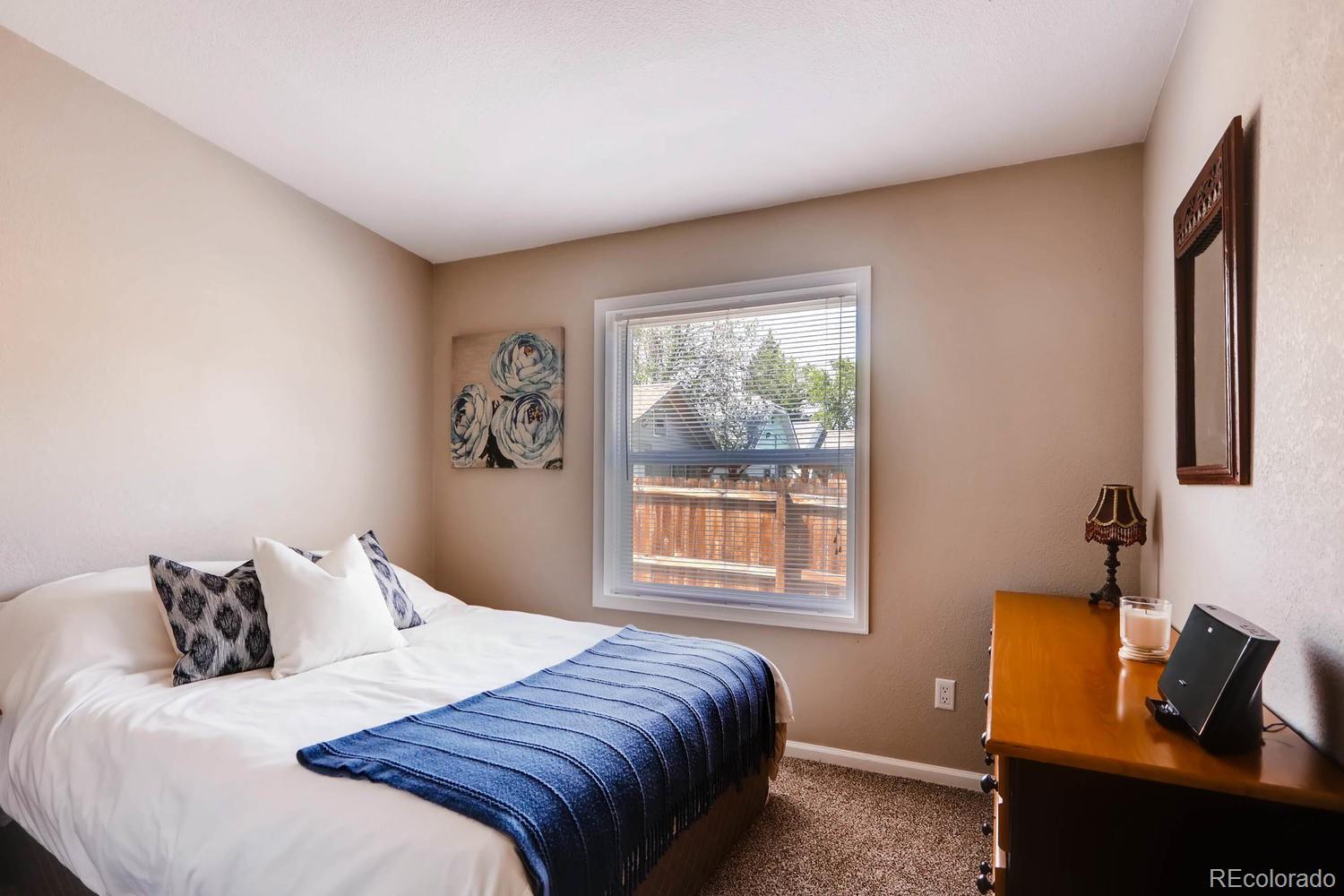 520 South Raleigh Street Denver, CO 80219 - Photo 20 of 27 a bedroom with bed and a window