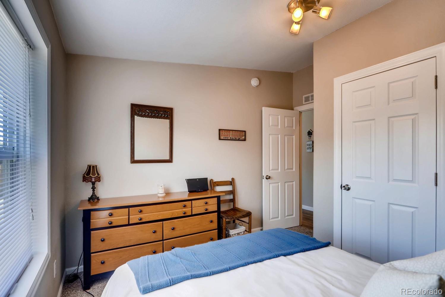 520 South Raleigh Street Denver, CO 80219 - Photo 21 of 27 a bedroom with a bed and a dresser