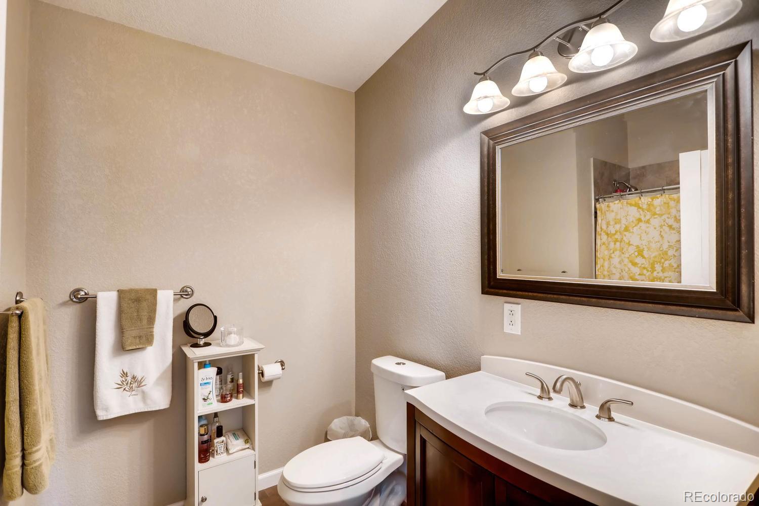 520 South Raleigh Street Denver, CO 80219 - Photo 23 of 27 a bathroom with a toilet a sink and mirror