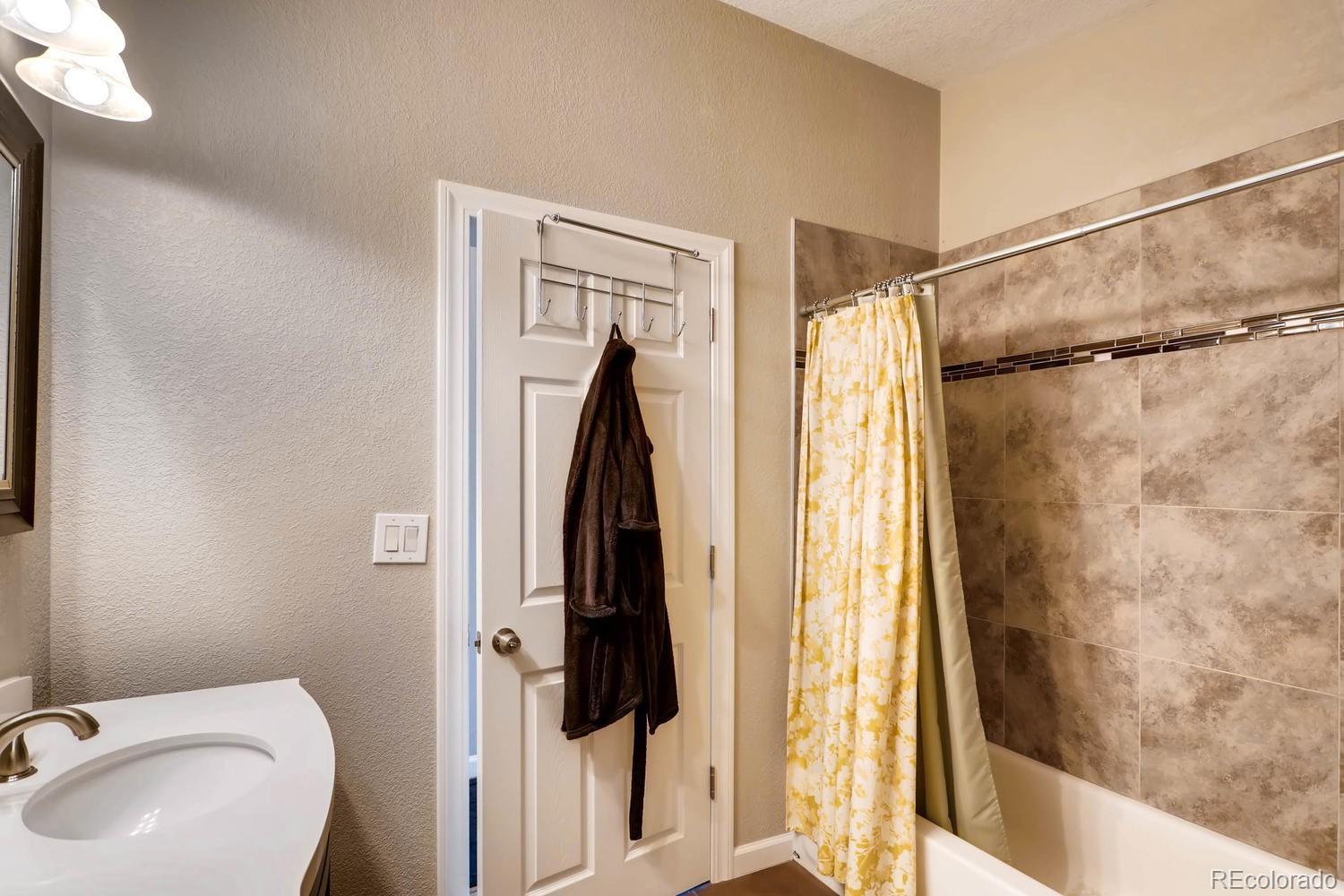 520 South Raleigh Street Denver, CO 80219 - Photo 24 of 27 a bathroom with a shower and a toilet