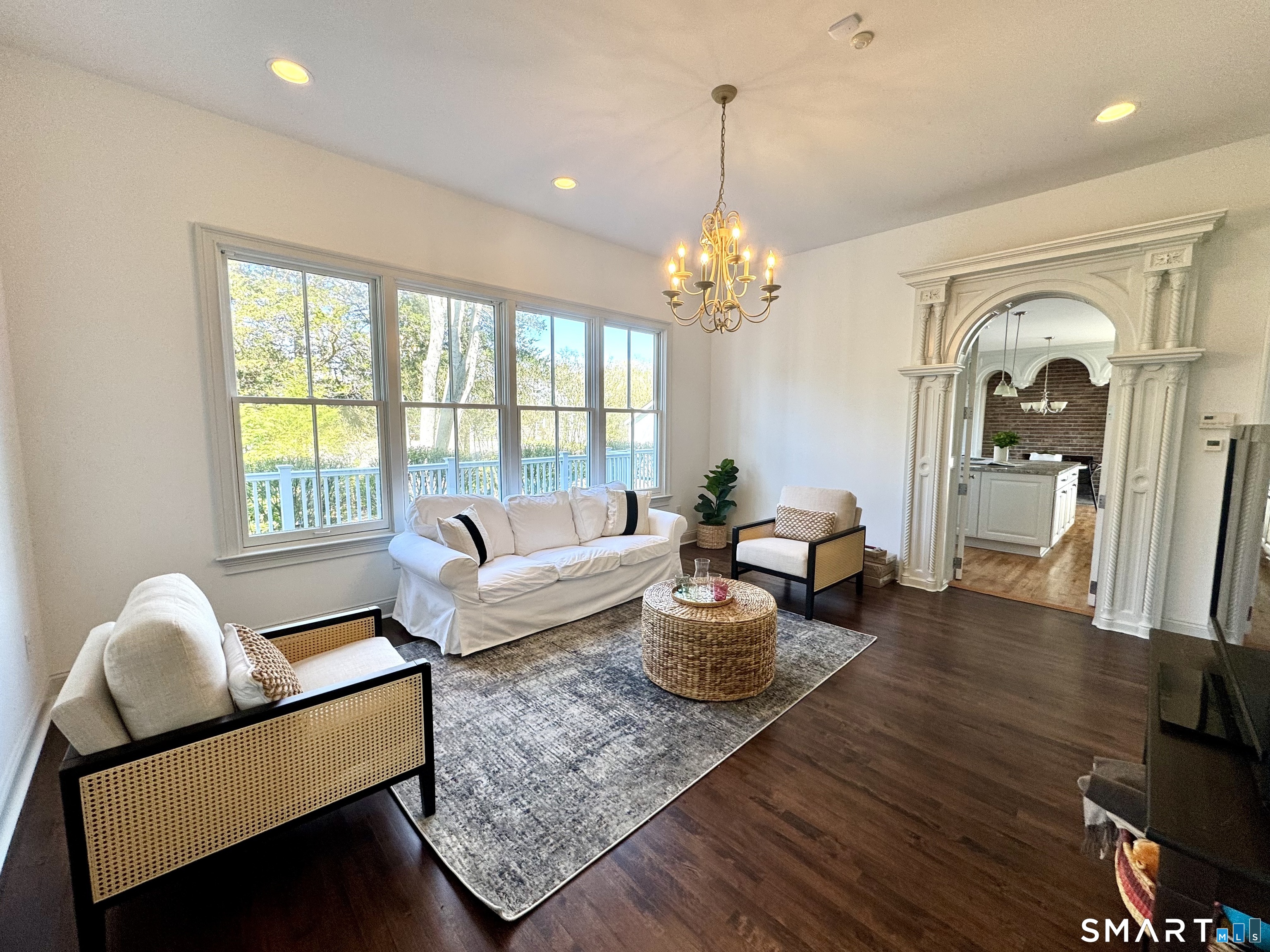 64 Webster Point Road Madison, CT 06443 - Photo 13 of 36 a living room with furniture chandelier and wooden floor