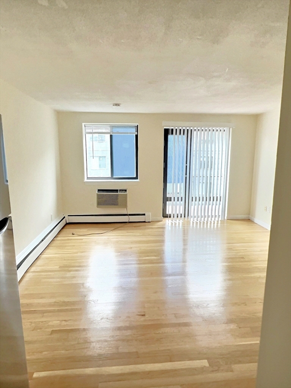 1039 Commonwealth Avenue, Unit 34 Boston, MA 02215 - Photo 4 of 6 a view of empty room with wooden floor
