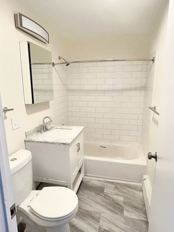 1039 Commonwealth Avenue, Unit 34 Boston, MA 02215 - Photo 5 of 6 a bathroom with a sink a toilet and shower