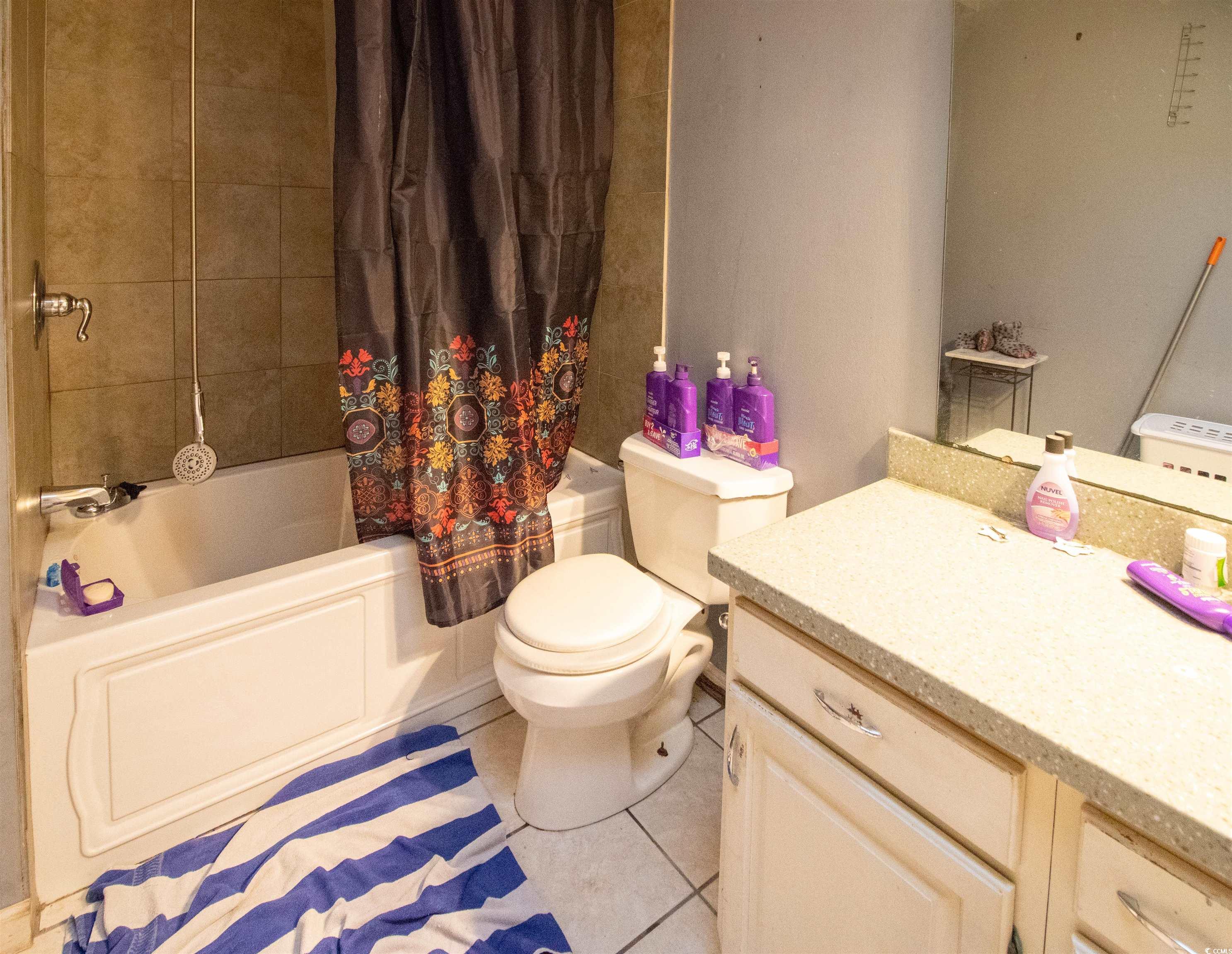 41 Channing Drive Little River, SC 29566 - Photo 11 of 19 Full bathroom featuring light tile patterned flooring, vanity, and shower / tub combo