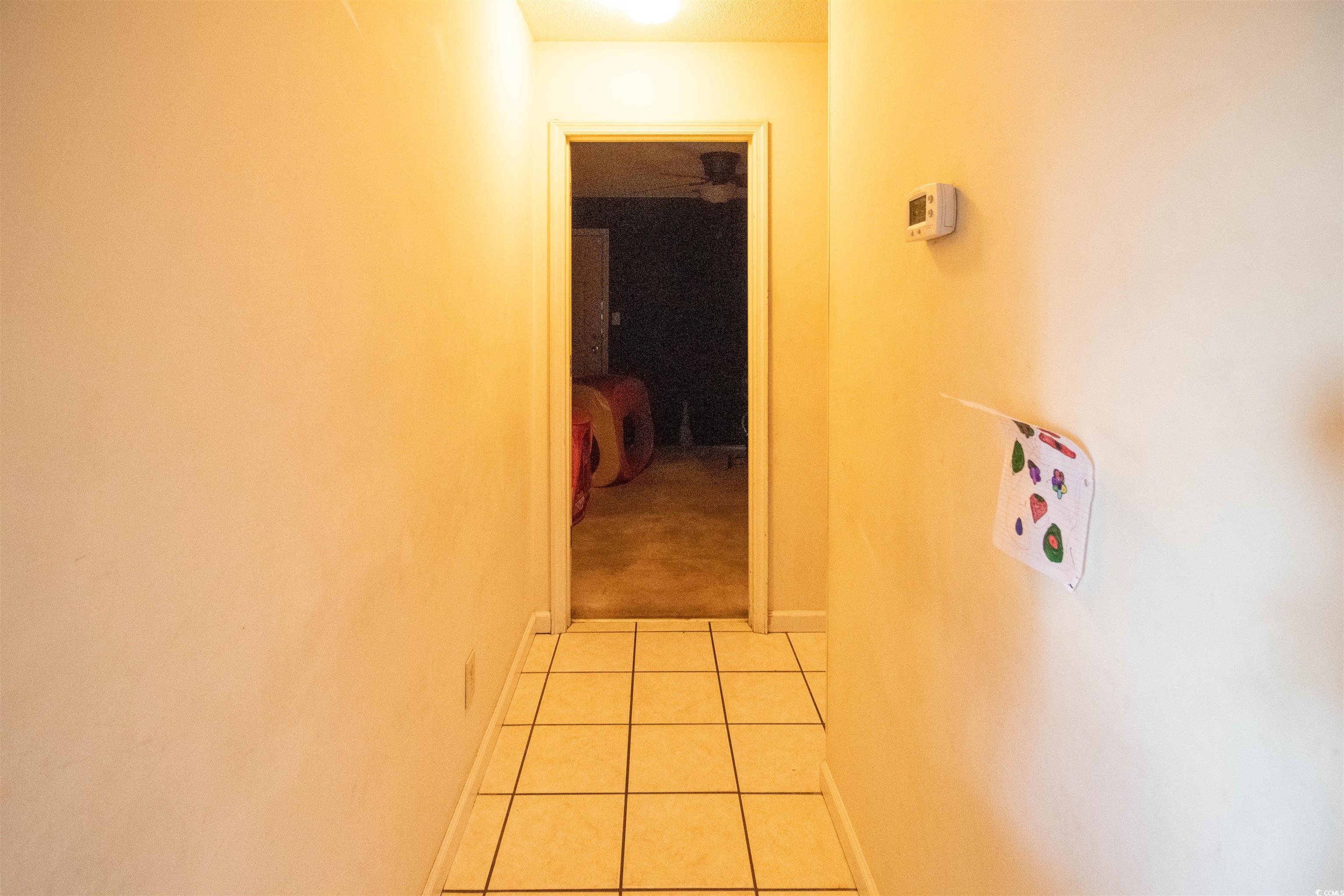 41 Channing Drive Little River, SC 29566 - Photo 10 of 19 Corridor with light tile patterned floors and baseboards