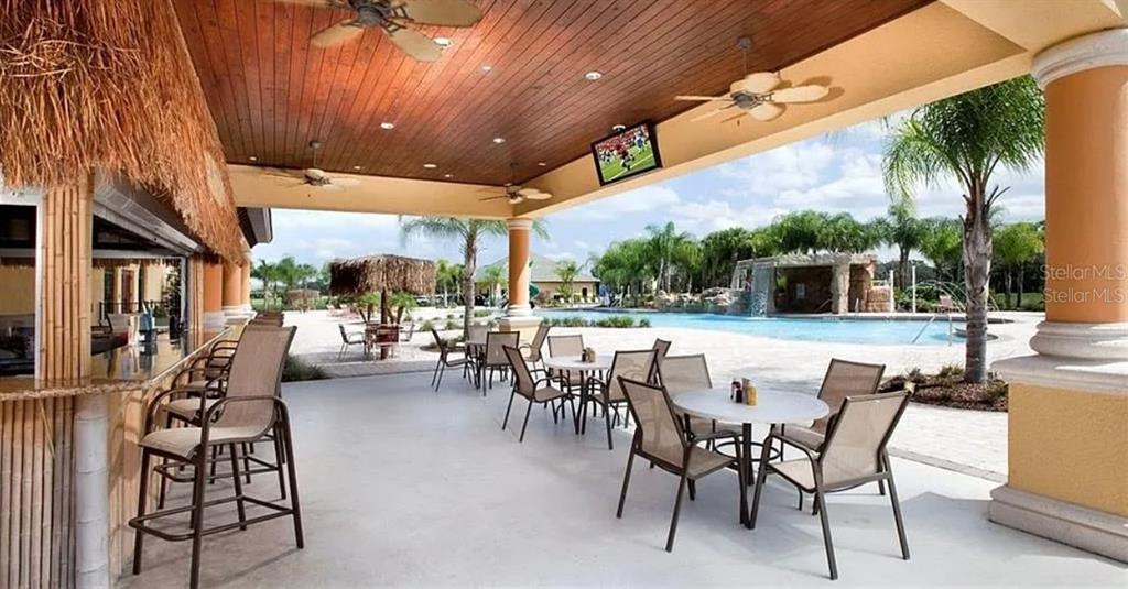 8961 Majesty Palm Road Kissimmee, FL 34747 - Photo 38 of 40 a outdoor space with lots of tables a garden view and chairs