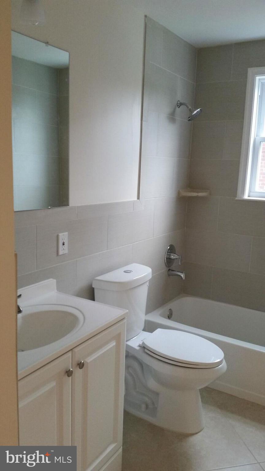 4845 Greencrest Road Baltimore, MD 21206 - Photo 13 of 28 a bathroom with a toilet sink and mirror