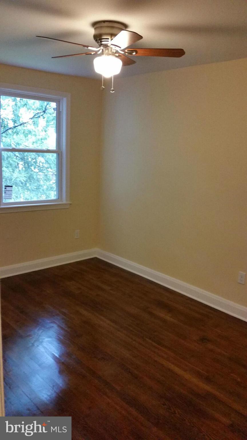 4845 Greencrest Road Baltimore, MD 21206 - Photo 19 of 28 a view of a room with wooden floor and window
