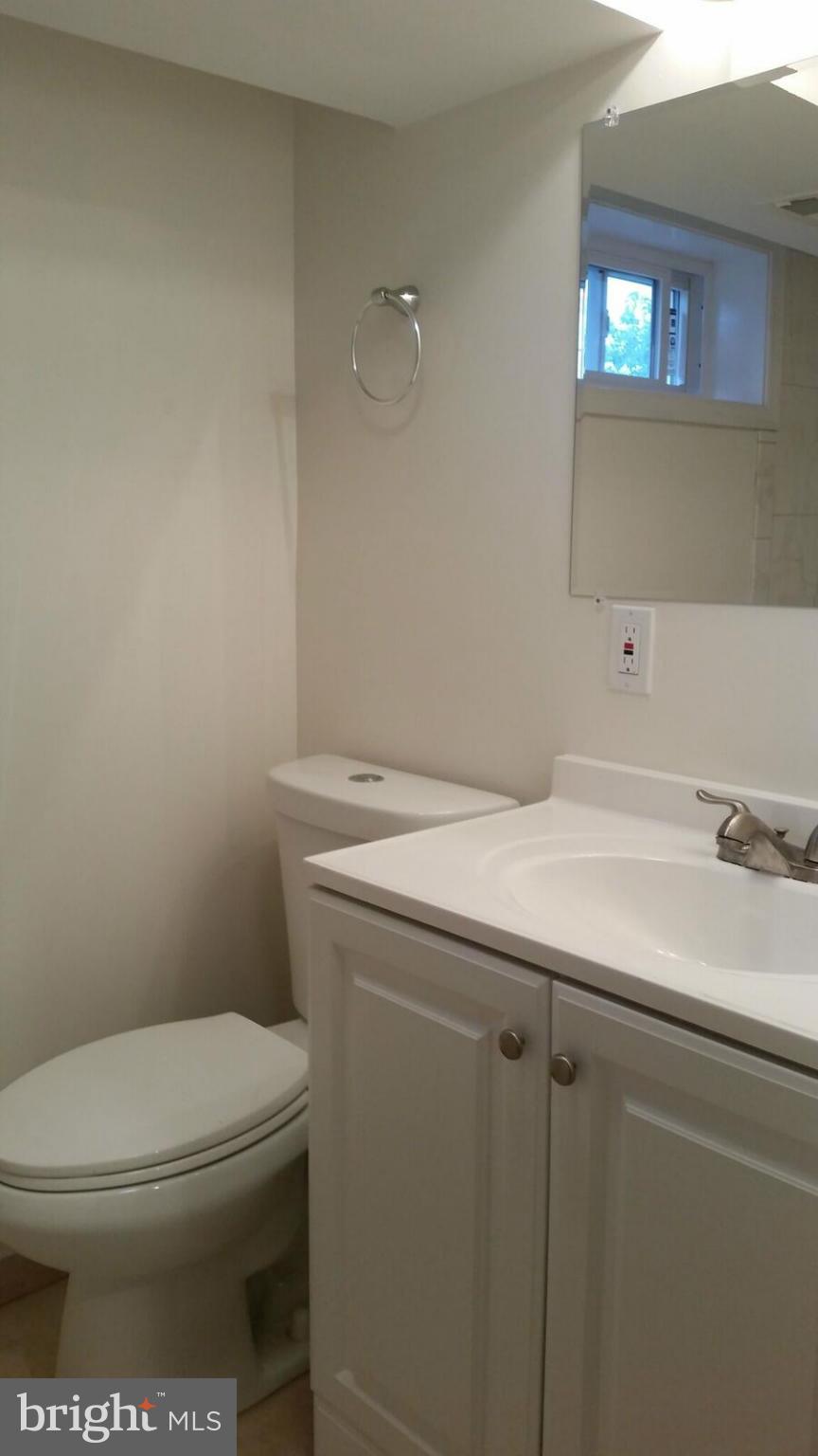 4845 Greencrest Road Baltimore, MD 21206 - Photo 23 of 28 a bathroom with a sink a toilet and a mirror