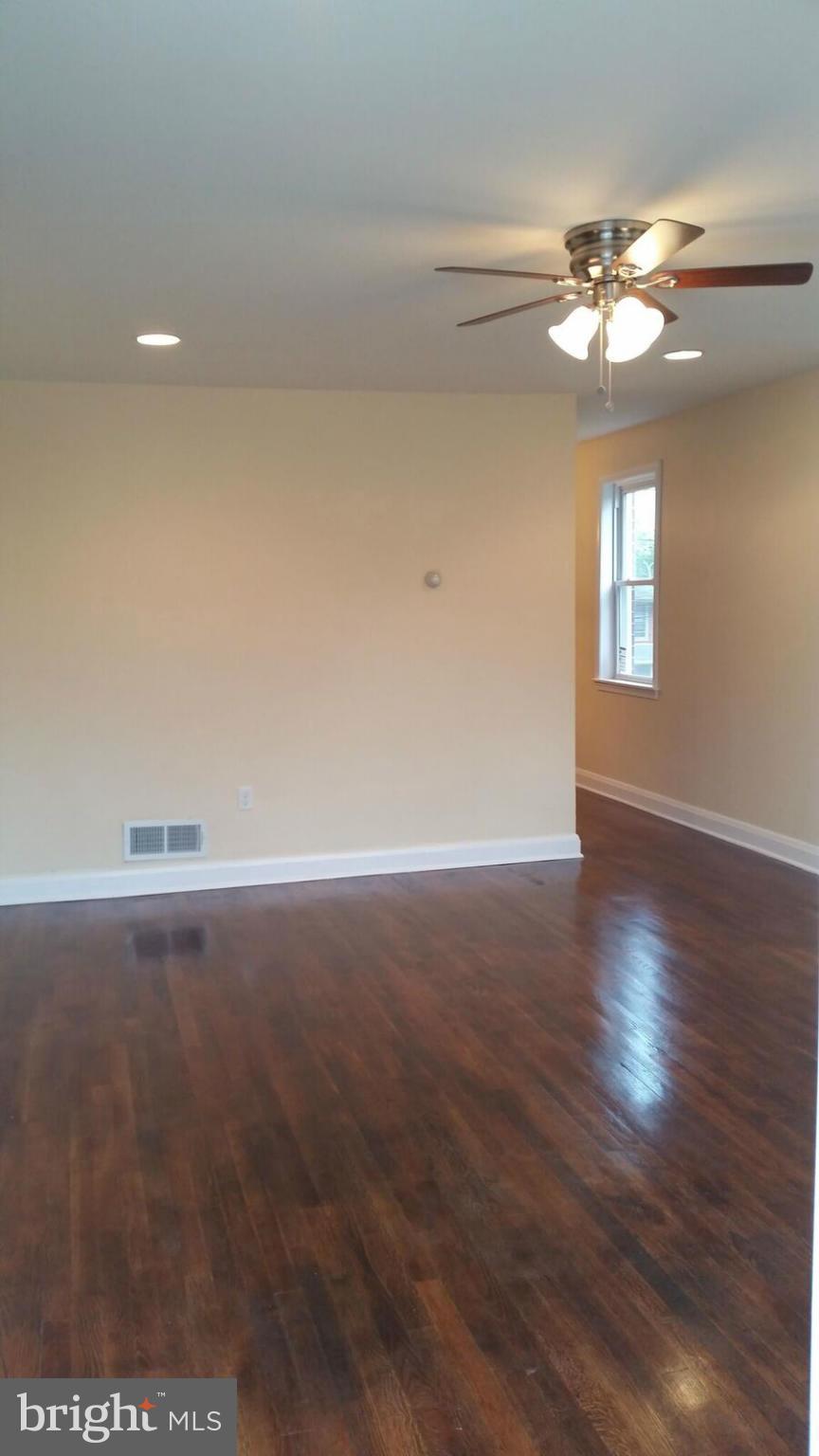 4845 Greencrest Road Baltimore, MD 21206 - Photo 5 of 28 a view of a room with wooden floor and ceiling fan