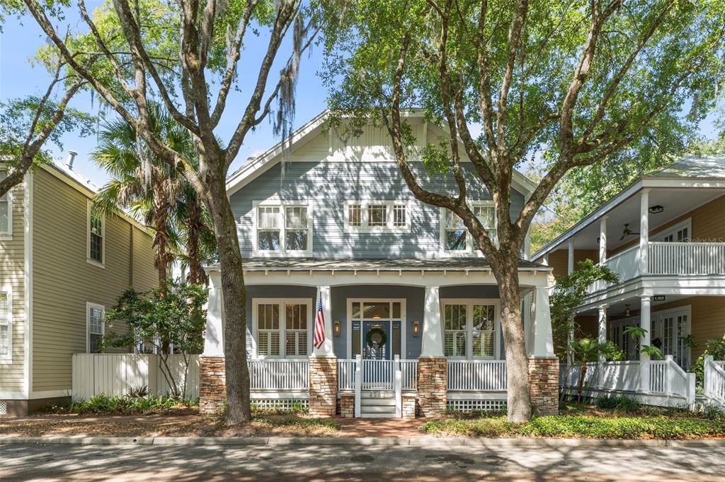 a front view of a house with a tree