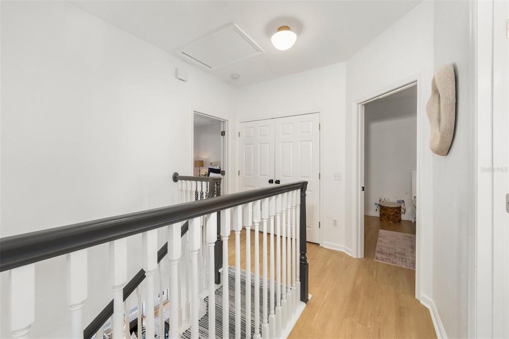 4964 Southwest 91st Drive Gainesville, FL 32608 - Photo 27 of 64 a view of a hallway with wooden floor and staircase