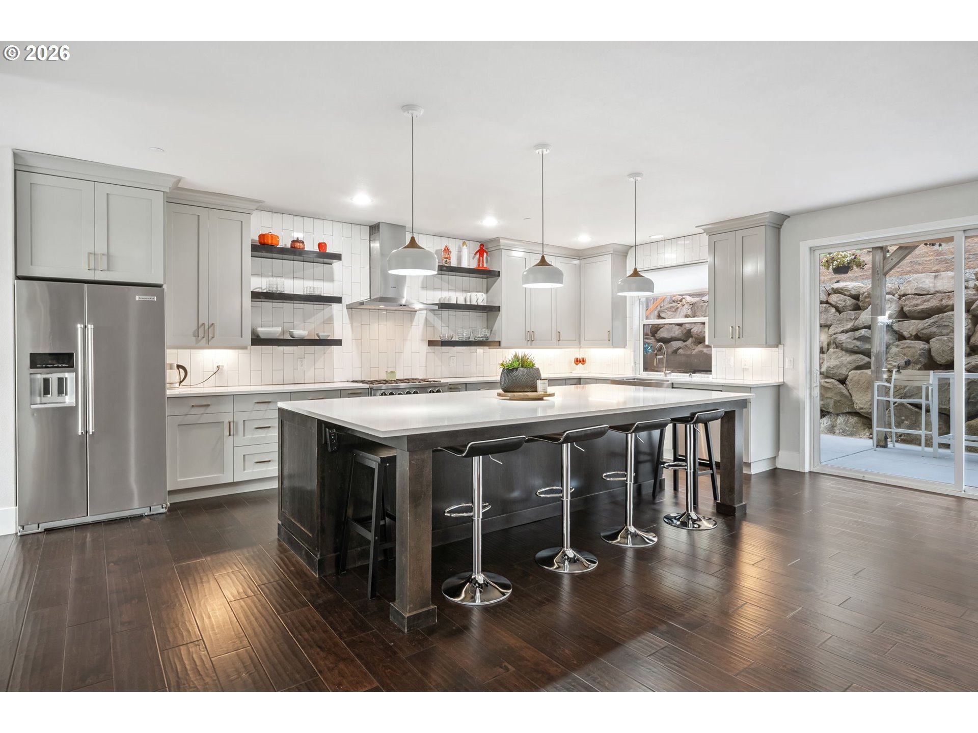 1730 Northwest Klickitat Street Camas, WA 98607 - Photo 13 of 48 a kitchen with stainless steel appliances granite countertop a table chairs sink refrigerator and cabinets