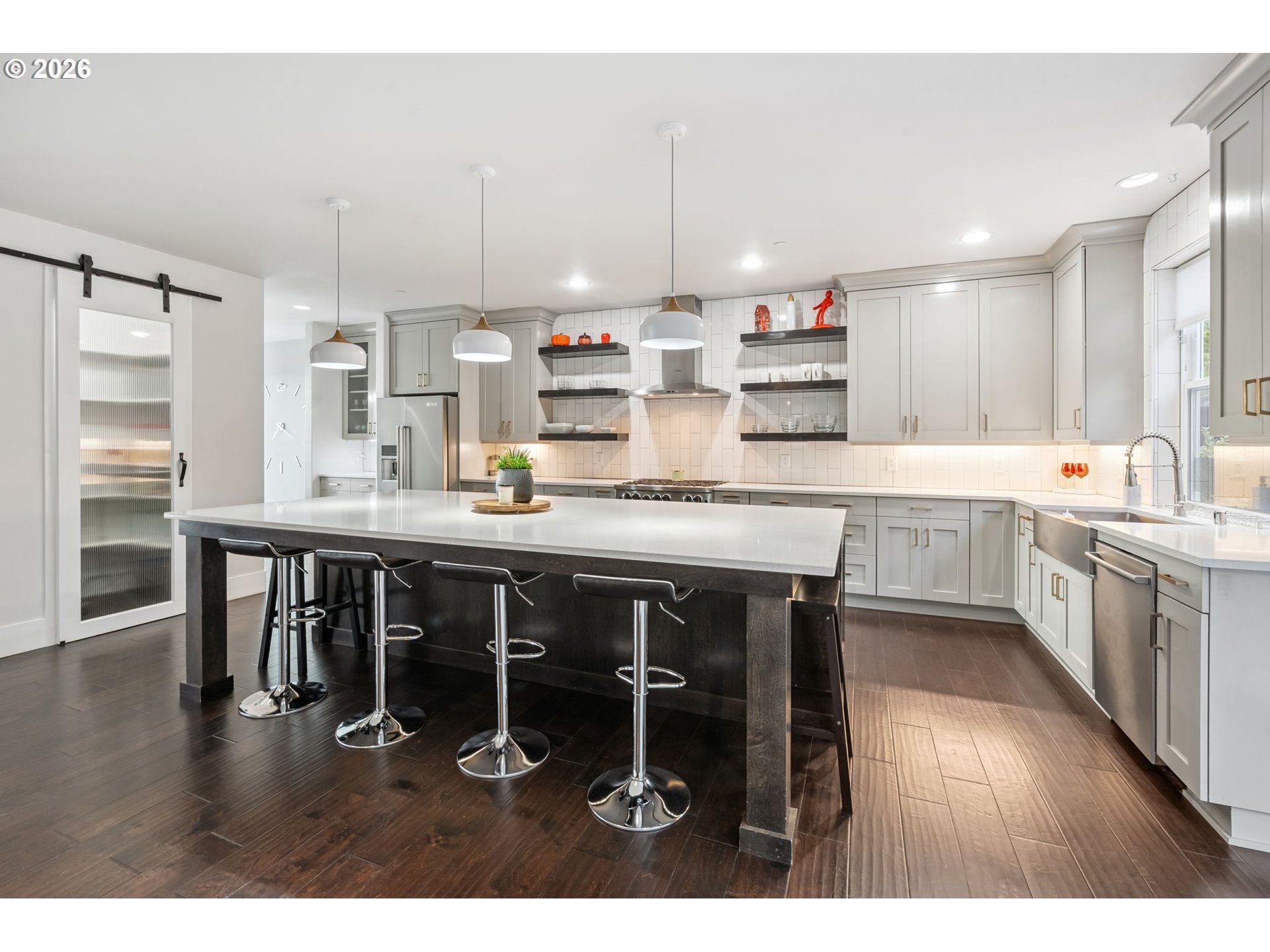 1730 Northwest Klickitat Street Camas, WA 98607 - Photo 14 of 48 a kitchen with stainless steel appliances granite countertop a table chairs sink and cabinets