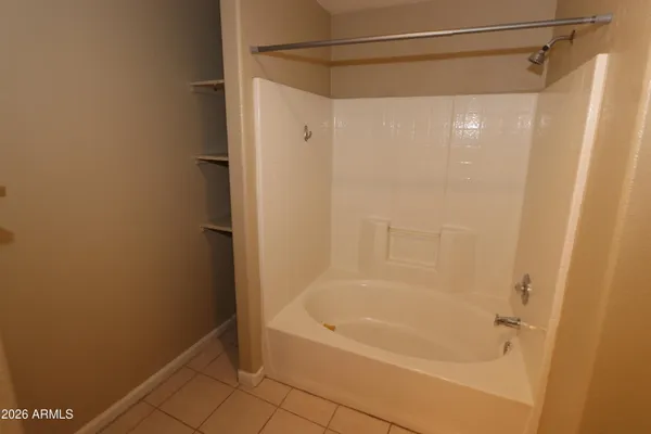 a bathroom with a shower and a bath tub