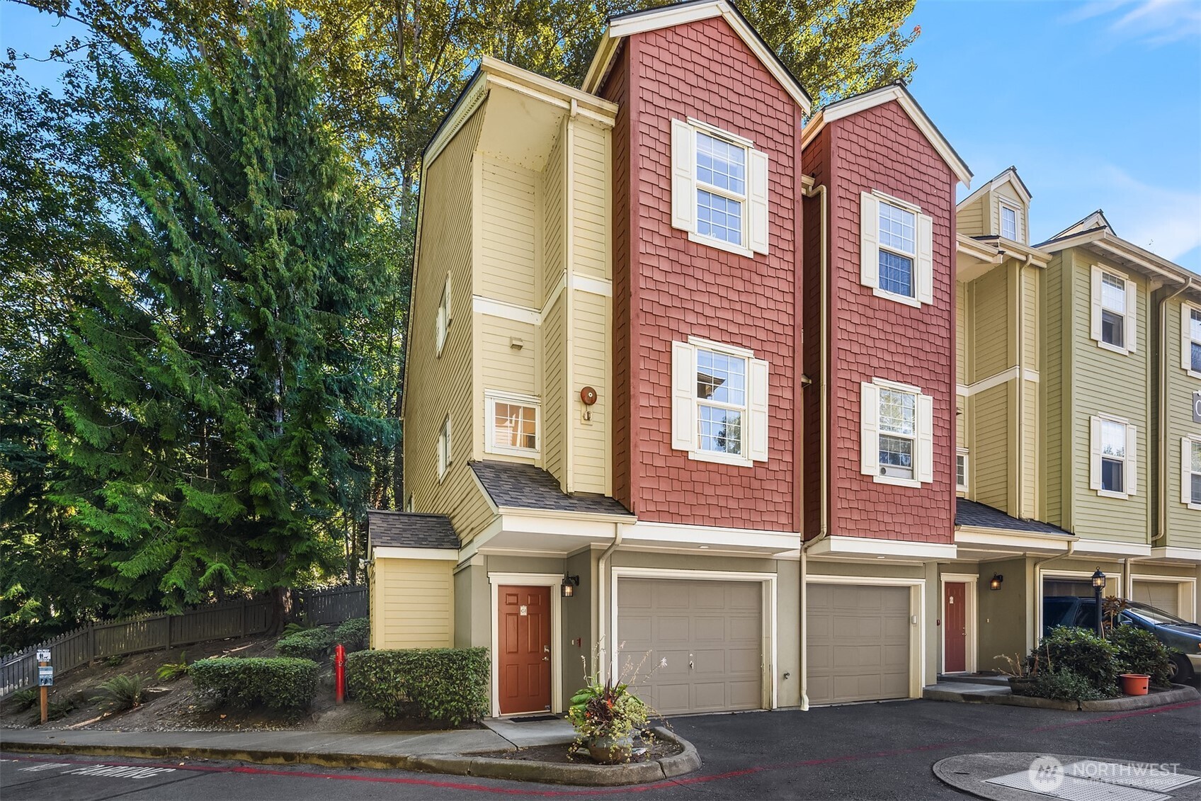 a front view of a multi story residential apartment building with yard