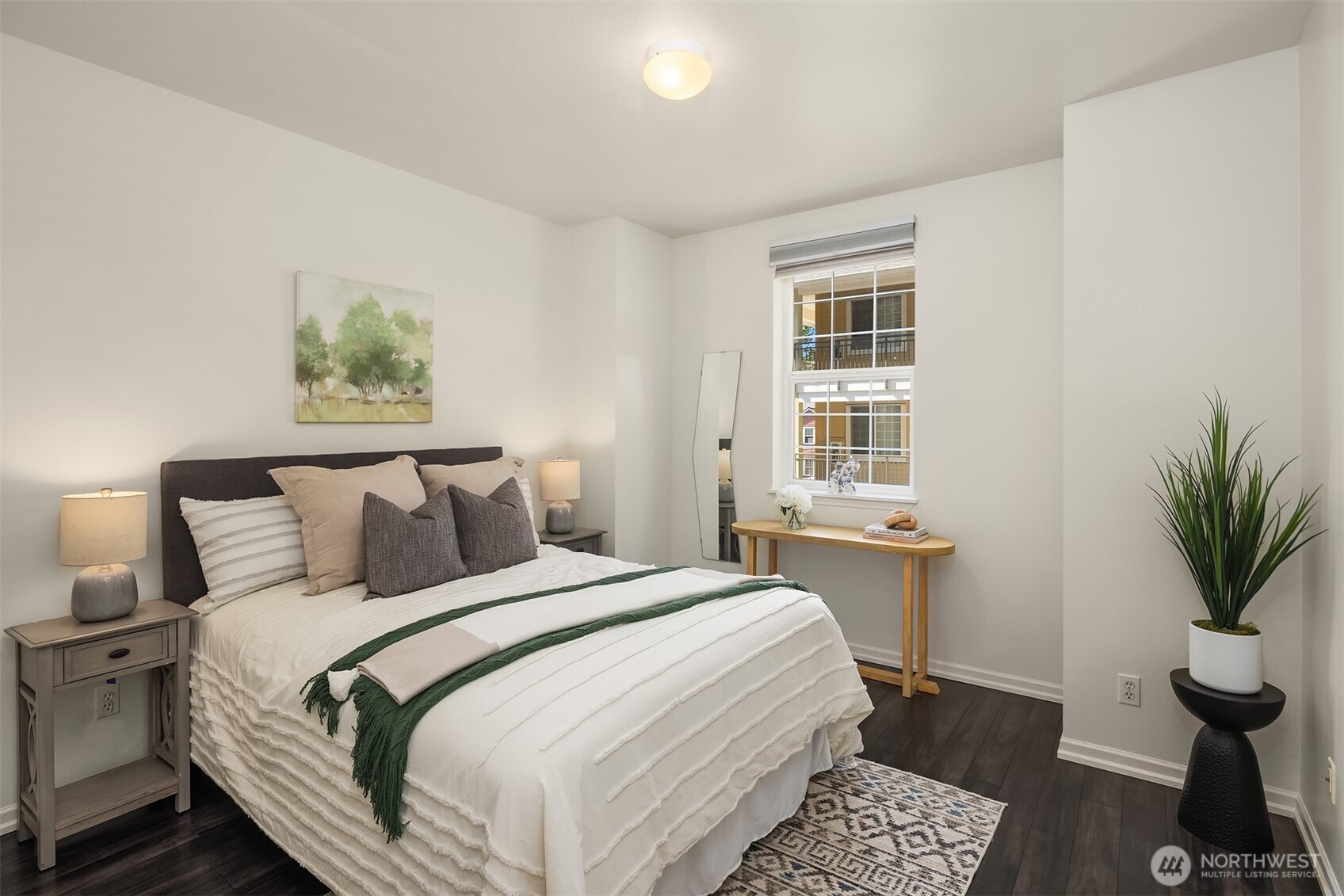 1800 Northeast 40th Street, Unit C1 Renton, WA 98056 - Photo 17 of 23 a bedroom with a large bed and a potted plant