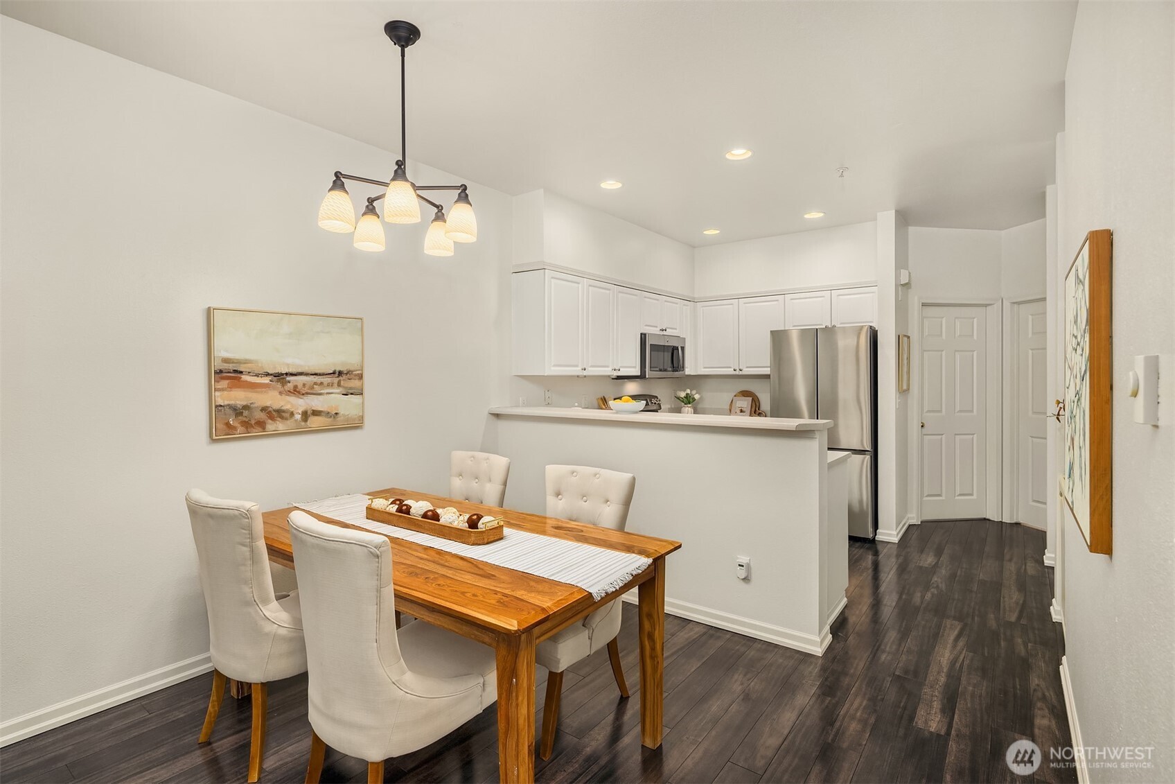 1800 Northeast 40th Street, Unit C1 Renton, WA 98056 - Photo 7 of 23 a kitchen with stainless steel appliances granite countertop a dining table chairs refrigerator and sink