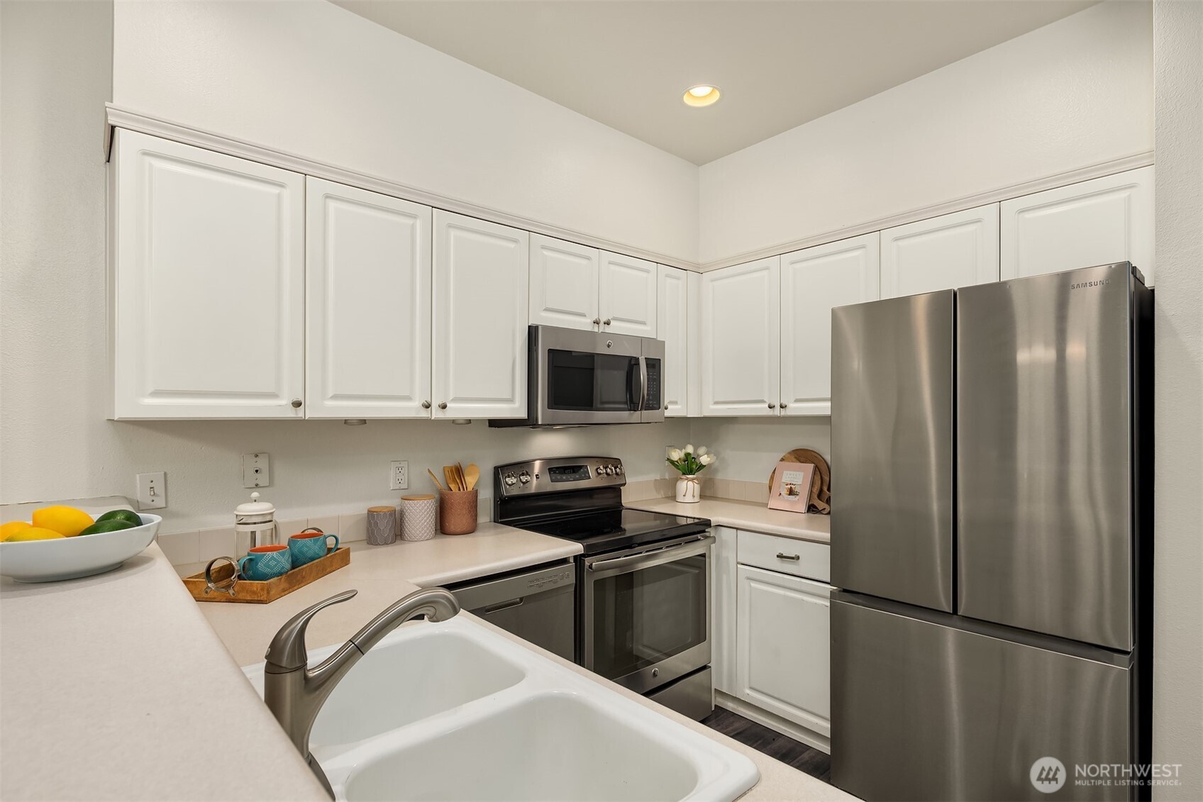 1800 Northeast 40th Street, Unit C1 Renton, WA 98056 - Photo 10 of 23 a kitchen with stainless steel appliances granite countertop a refrigerator sink and white cabinets