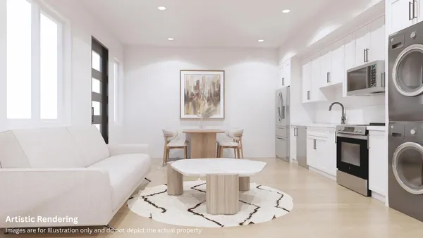 a living room with furniture a rug and kitchen view