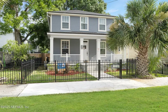 a view of a house with a backyard and a patio