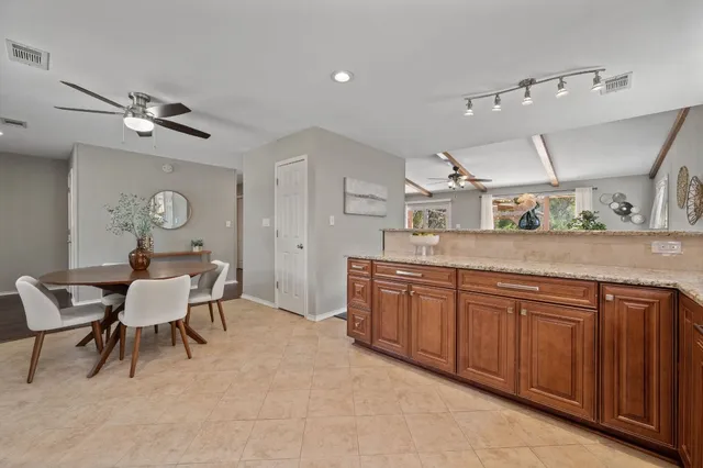 a view of a kitchen area with furniture and wooden floor