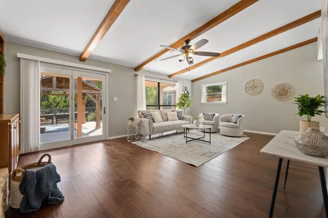 a living room with furniture and wooden floor