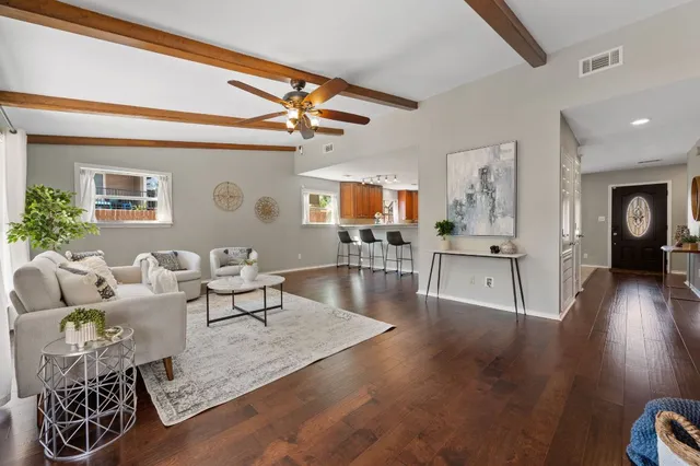 a living room with furniture and wooden floor