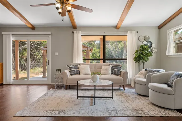 a living room with furniture and a potted plant