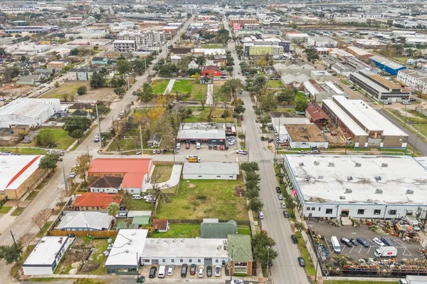 an aerial view of residential houses with outdoor space and parking