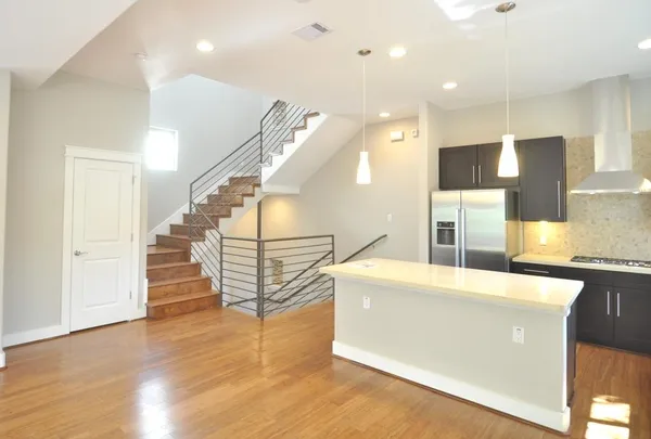 a view of a kitchen with cabinets and wooden floor