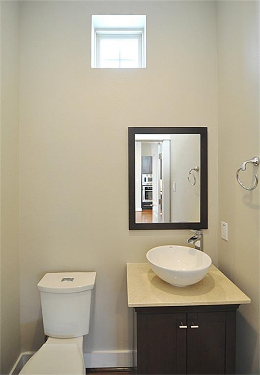 4303 Dickson Street, Unit A Houston, TX 77007 - Photo 13 of 30 a bathroom with a toilet sink and mirror