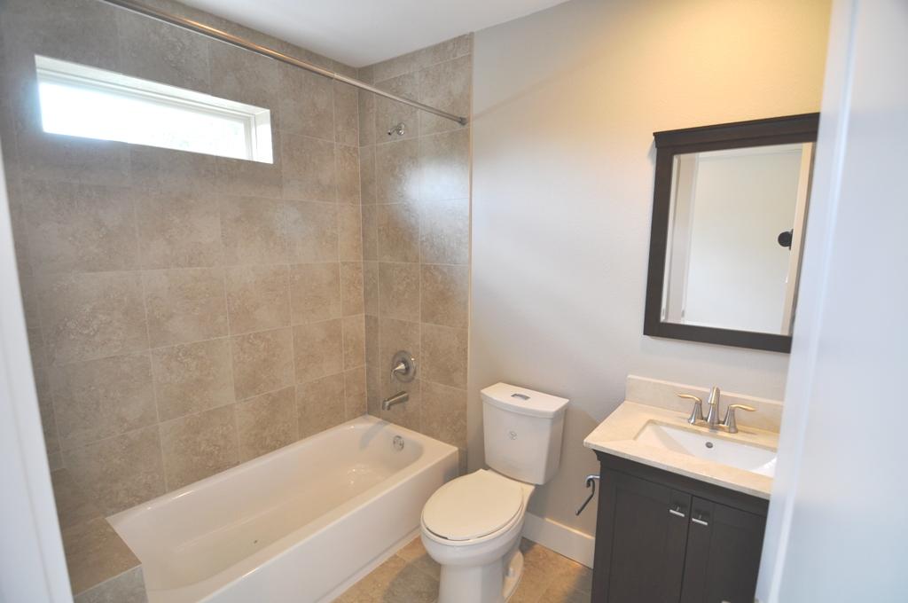 4303 Dickson Street, Unit A Houston, TX 77007 - Photo 14 of 30 a bathroom with a sink a toilet and a mirror