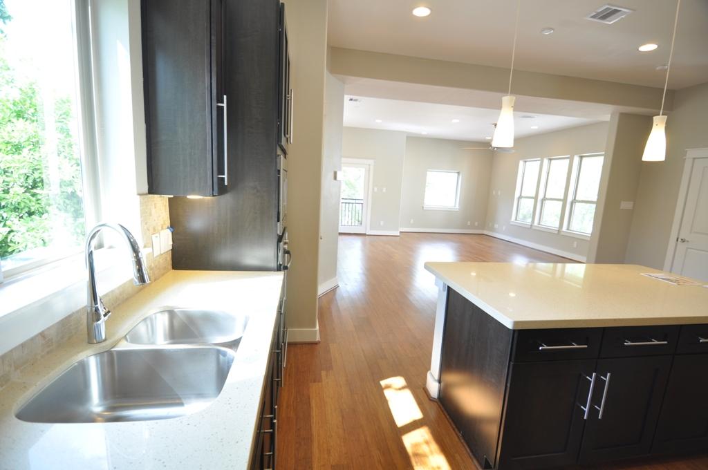 4303 Dickson Street, Unit A Houston, TX 77007 - Photo 30 of 30 a kitchen with a sink a counter top space and a window