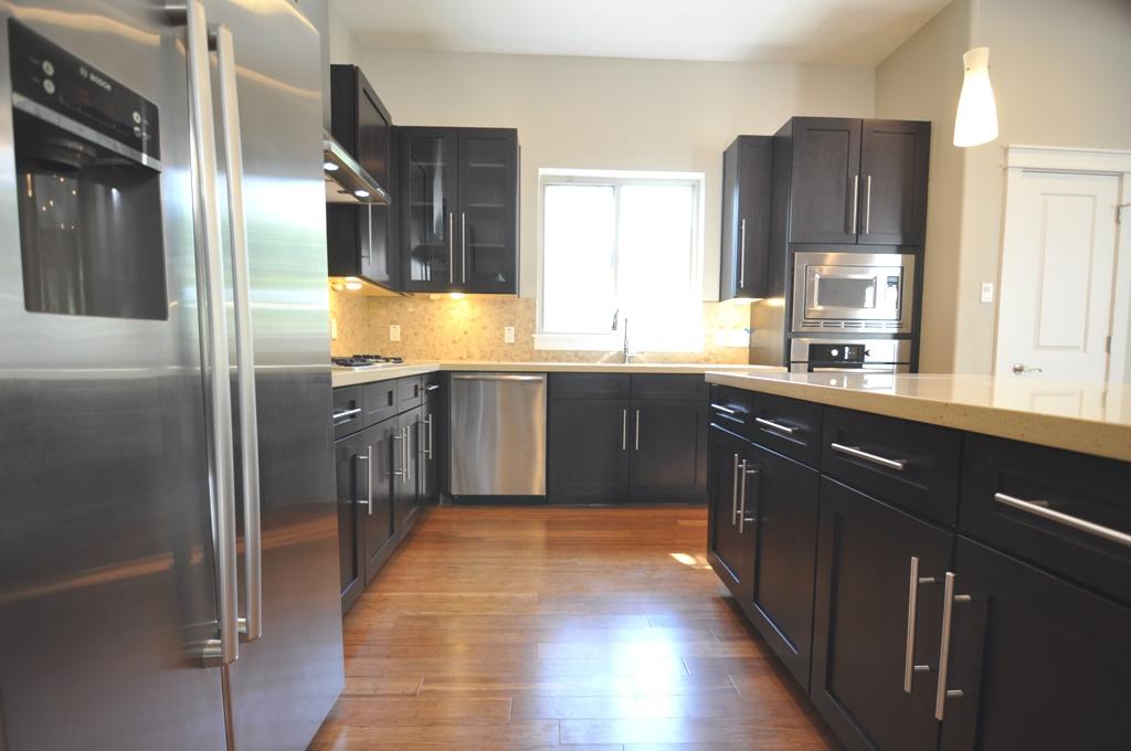 4303 Dickson Street, Unit A Houston, TX 77007 - Photo 3 of 30 a kitchen with stainless steel appliances granite countertop a sink counter space and cabinets