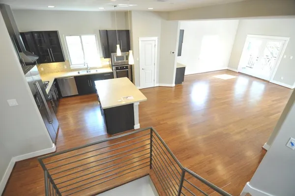 a view of a living room with furniture and wooden floor