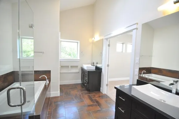 a bedroom with a bed and dresser with mirror