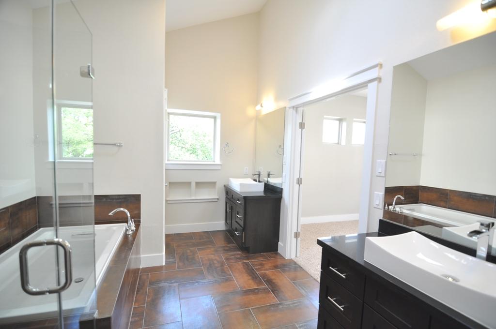 4303 Dickson Street, Unit A Houston, TX 77007 - Photo 9 of 30 a bedroom with a bed and dresser with mirror