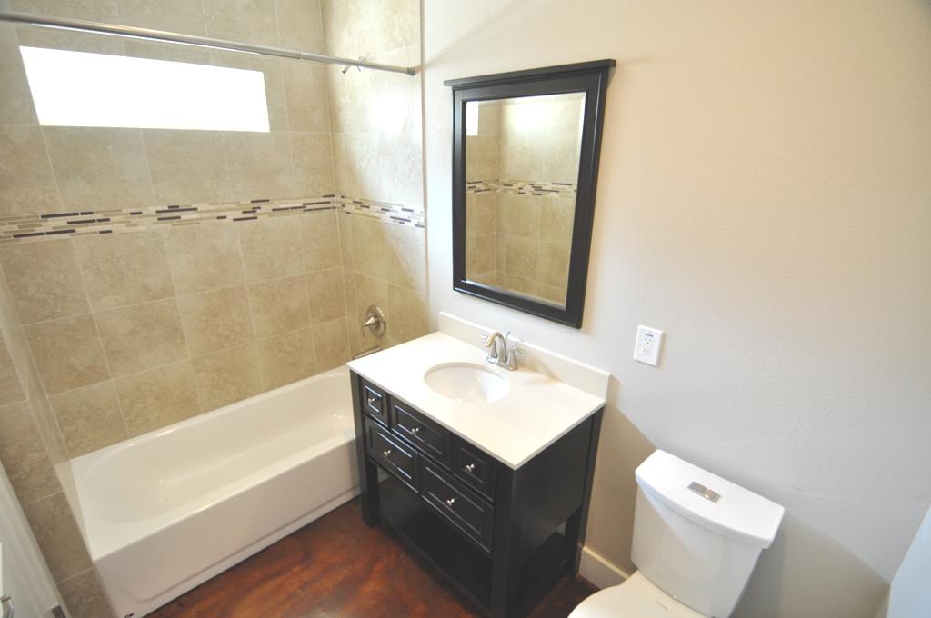 4303 Dickson Street, Unit A Houston, TX 77007 - Photo 10 of 30 a bathroom with a sink a toilet and shower