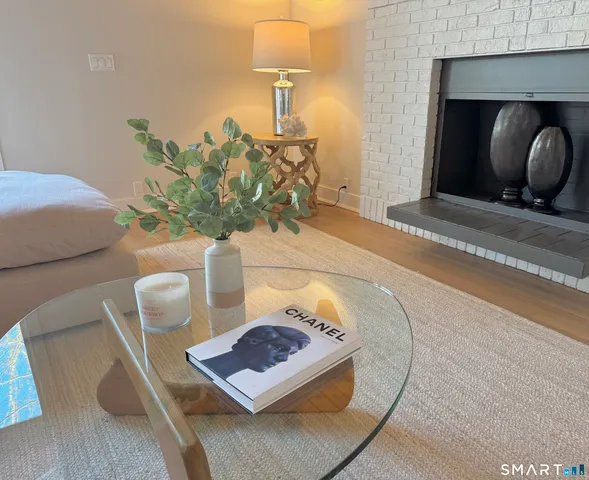 a bedroom with a bed a table and a lamp