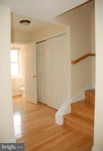 73 Timber Rock Road Gaithersburg, MD 20878 - Photo 8 of 25 Main level hall, closet leading to powder room