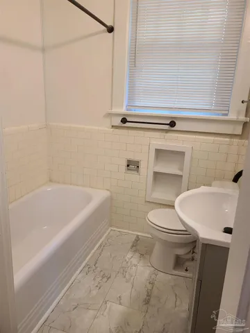 a bathroom with a sink a toilet and bathtub