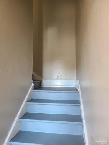 a view of staircase with white walls