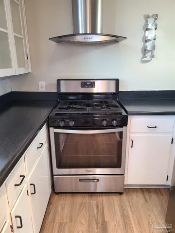 a stove top oven sitting inside of a kitchen