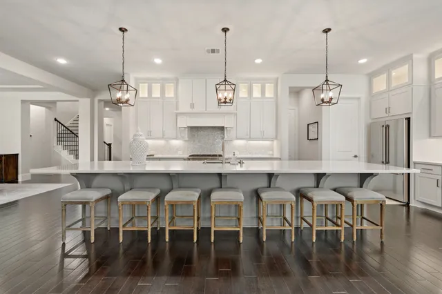 a large kitchen with a table and chairs in it