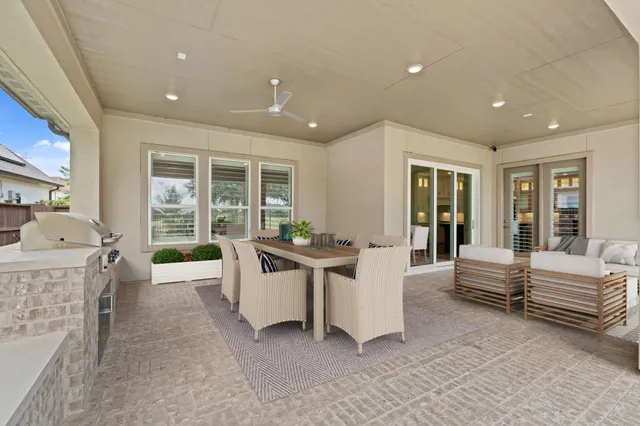 a view of a patio with table and chairs