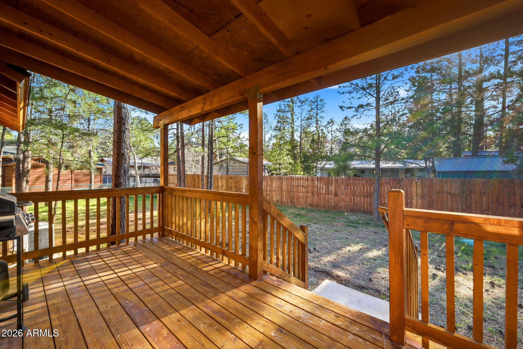 2900 Long Rifle Place Overgaard, AZ 85933 - Photo 20 of 35 a view of a balcony with wooden floor next to a yard