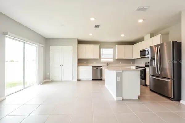 a kitchen with stainless steel appliances a refrigerator sink and cabinets